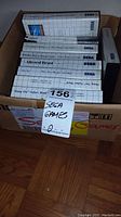 Box containing ten Sega Genesis game cartridges in original boxes with titles visible on spines.