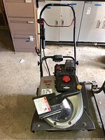 Front view of entire snow blower showing housing, chute and handles