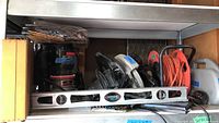 Power tools including Sears Craftsman circular saw, electric router, Black & Decker jigsaw and drill, cordless mini screwdriver, drill bit set, extension cord, and level.