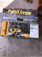 Original packaging box showing Wagner Paint Crew branding and model details with worn condition and tape repair.