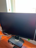 Front view of a Dell 26-inch computer monitor with stand, monitor is off and screen is black.