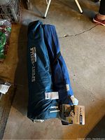 Sport-Brella Recliner Chair folded inside original blue bag showing the branding Sport-Brella.