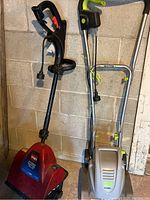 Photo of Toro Power Shovel Plus and Earthwise tiller/cultivator side by side, showing red and silver colors, handles, and cords