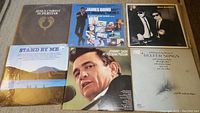 Six vinyl LP covers face-up: Jesus Christ Superstar; James Bond 007 Original Themes; The Blues Brothers; Stand By Me; Johnny Cash at Folsom Prison; Reefer Songs