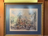 Full view of framed print showing Basilica of Sacré-Cœur scene with blue mat and gold-tone frame.