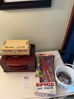Photo of two wooden jewelry boxes, Spice Girls Barbie doll in original box, and bucket with geodes.