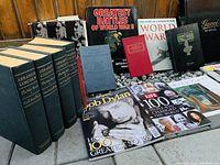 Photo shows a lineup of books focusing on American history, world wars, and literature, including large volumes on Abraham Lincoln and a Gucci book.