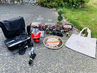 Overview of entire lot showing various items on pavement and grass background