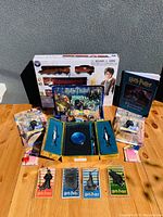 Full view of all Harry Potter collectibles including train set box, hardcover books, collector's sets, bookmarks, and action figures.