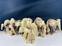 Seven figurines arranged in single row