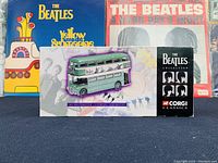 Front view of the unopened box showing the themed AEC Routemaster bus and Beatles branding.