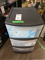 Full view of the 3-drawer clear plastic organizer unit with black top, showing size and label.