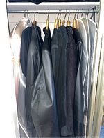 Overview of six women’s XL outerwear pieces hung on rack