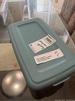 Labeled plastic box with lid indicating FED Creations polymer clay pendant sets.