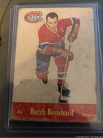 Front of 1955-56 Parkhurst Butch Bouchard hockey card in protective sleeve, showing player image and team colors.
