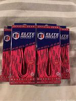 Five packs of pink Elite Hockey waxed skate laces, each 84 inches in length, displayed on packaging showing brand and lace details.