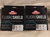 Two unopened spools of Berkley Fluoroshield fishing line, front view showing brand and product name.