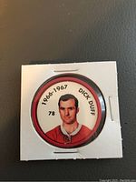 Front of the hockey coin showing Dick Duff's photo, year, and number 78 in a white and red border inside a cardboard holder.