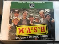 Photo of the front of the empty M*A*S*H trading card wax box showing cast, logo, and original count/price.