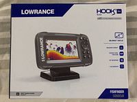 Front of sealed box showing Lowrance Hook2 Bullet 4x fishfinder unit with display image and features.