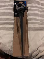 Front view of the full 16 inch adjustable spud wrench in packaging, shows the length, handle and wrench jaw.