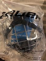 New Bauer hockey cage in original sealed plastic packaging, size small.