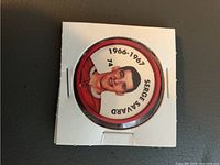 Front side of hockey coin featuring Serge Savard with his portrait, name, jersey number 74, and season year 1966-1967 in a protective white cardboard holder.