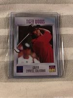 Front side of Tiger Woods trading card showing golf image and identifying details.