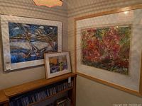 Three framed artworks hung and placed on a bookshelf corner, showing size and composition of each painting.