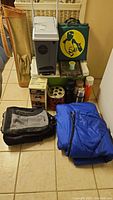 Full lot view showing coolers, bags, thermoses, camping heater and accessories.