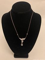 Full front view of necklace on black display bust