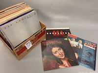 Box containing over 50 assorted vinyl record albums including VSP Project, U.S.A. Orchestra, Victoria Cardona and more.