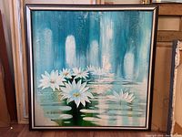 Frontal view of the framed oil painting showing the white flowers and blue-green abstract water background.