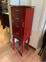 Full view of the jewelry box showing the flip top lid and cabriole legs.