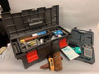 Photo of black plastic toolbox open displaying hand tools and the ideal voltage tester with leather case.