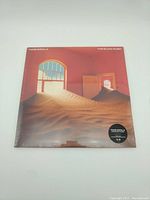 Front cover of the sealed vinyl with desert artwork and Tame Impala The Slow Rush title.