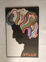 Framed vintage Bob Dylan poster showing front view of the psychedelic colorful silhouette artwork under glass.