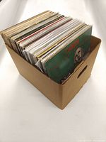 Corrugated cardboard storage box filled with 12-inch vinyl records