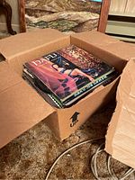 Open box showing stacked vinyl albums inside the box
