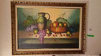 Full view of the vintage still life painting framed and matted, showing grapes, apples, cherries, pears, and a ceramic jug.