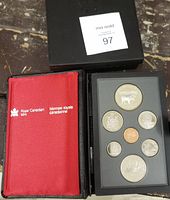 Entire proof coin set in original Royal Canadian Mint presentation case showing coins set in black tray and red interior cover.