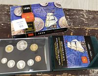 1999 Royal Canadian Mint proof set with ship imagery and coins inside green case