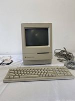 Front view showing computer, keyboard, mouse cable, manuals, and startup disks