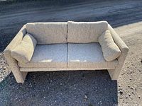 Front view showing textured upholstery, two seat cushions, and two back cushions with arm cushions
