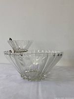 Side view of large bowl with smaller bowl held on top by metal holder.