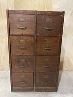 Front view of two side-by-side wooden filing cabinet units showing four drawers each