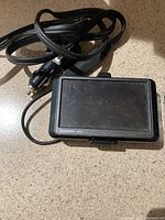 Front top view of a Garmin nüvi GPS unit with cable attached, showing screen and casing