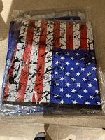Folded American flag themed t-shirt sealed in plastic packaging