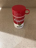 Front view of the closed Campbell’s Soup Can-tainer showing red and white soup can label with gold seal.
