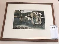 Framed watercolour painting with house and pond scene inside a wooden frame with lot tag visible